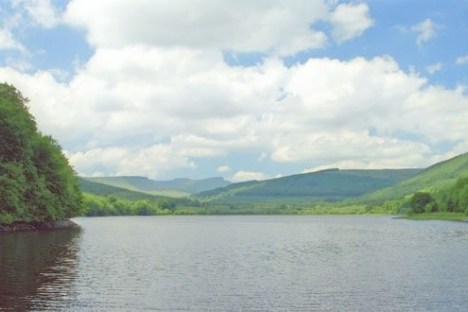 a body of water with a mountain in the middle of a lake