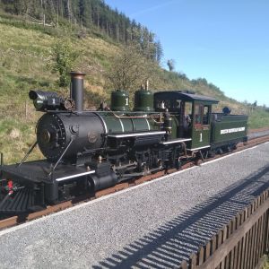 a steam engine train traveling down train tracks