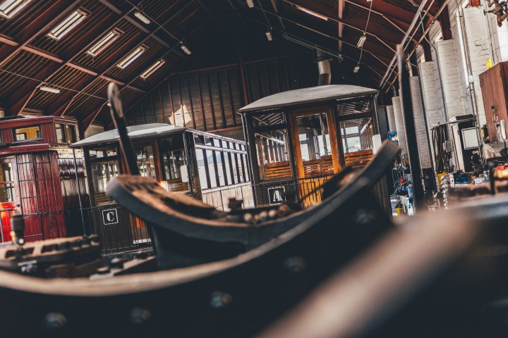 a train is parked on the side of a building
