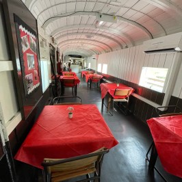 a train that is sitting on a chair in a room
