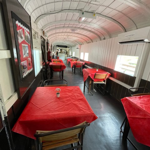 a train that is sitting on a chair in a room