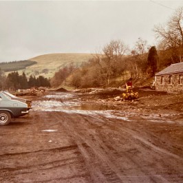 a car parked on the side of a dirt road