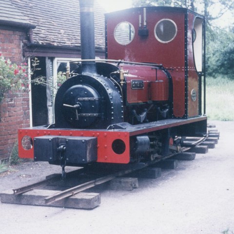a train is parked on the side of a building