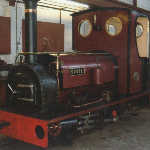 a train is parked on the side of a building
