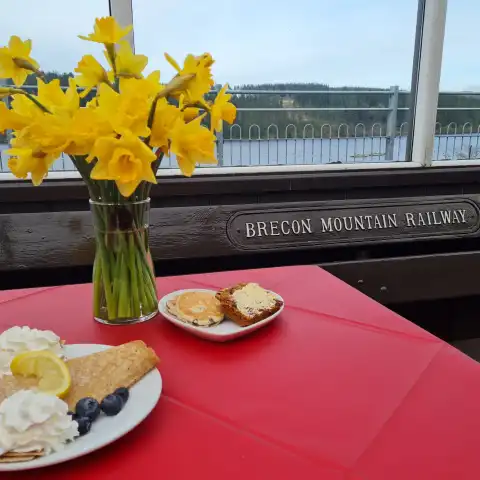 a plate topped with a vase of flowers on a table