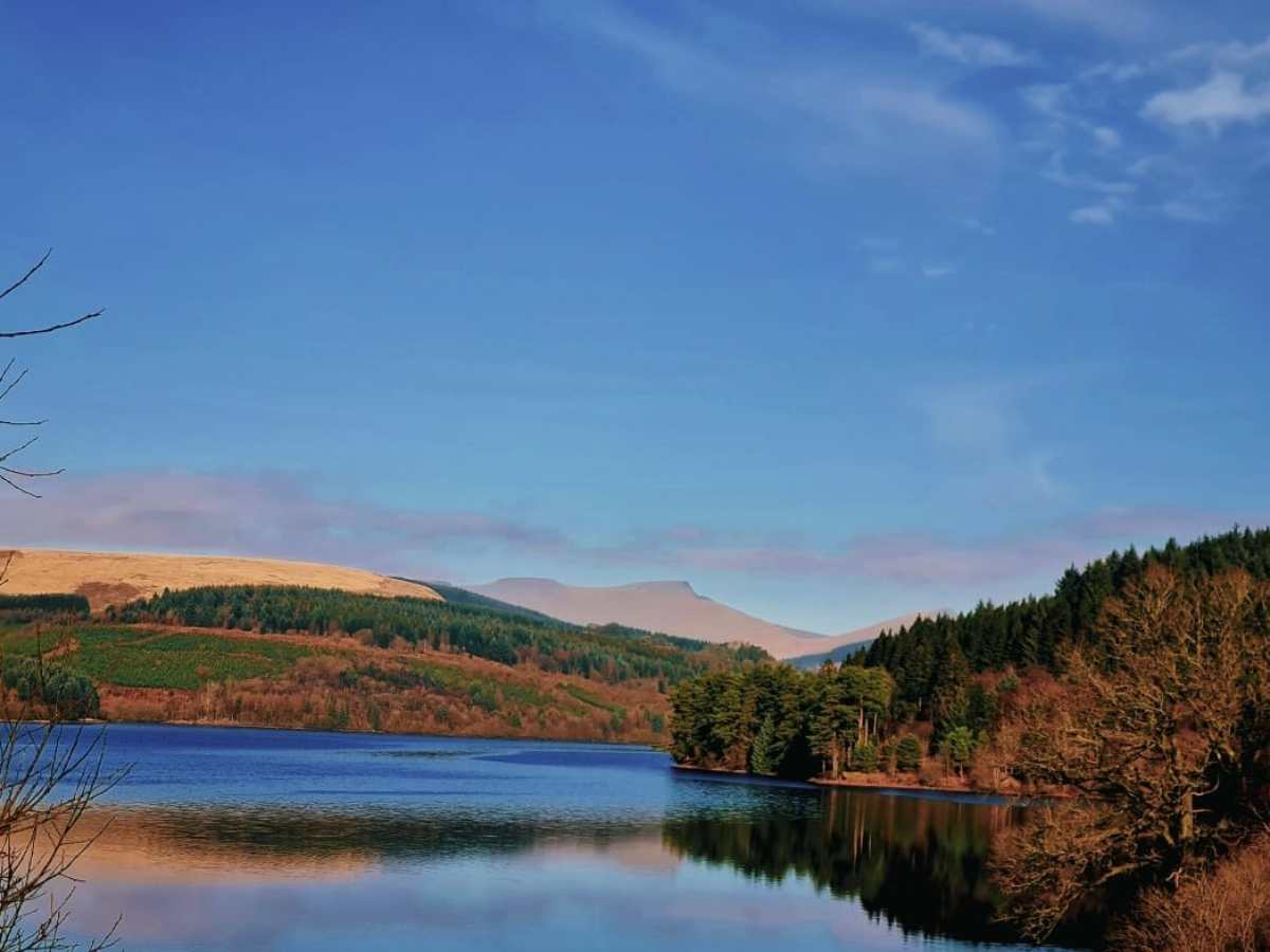 a body of water with a mountain in the background