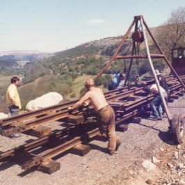 a man sitting on top of a dirt field