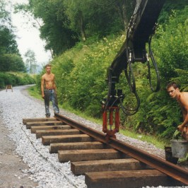 a man riding a bike down a dirt road