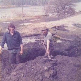 a group of people standing on top of a dirt field