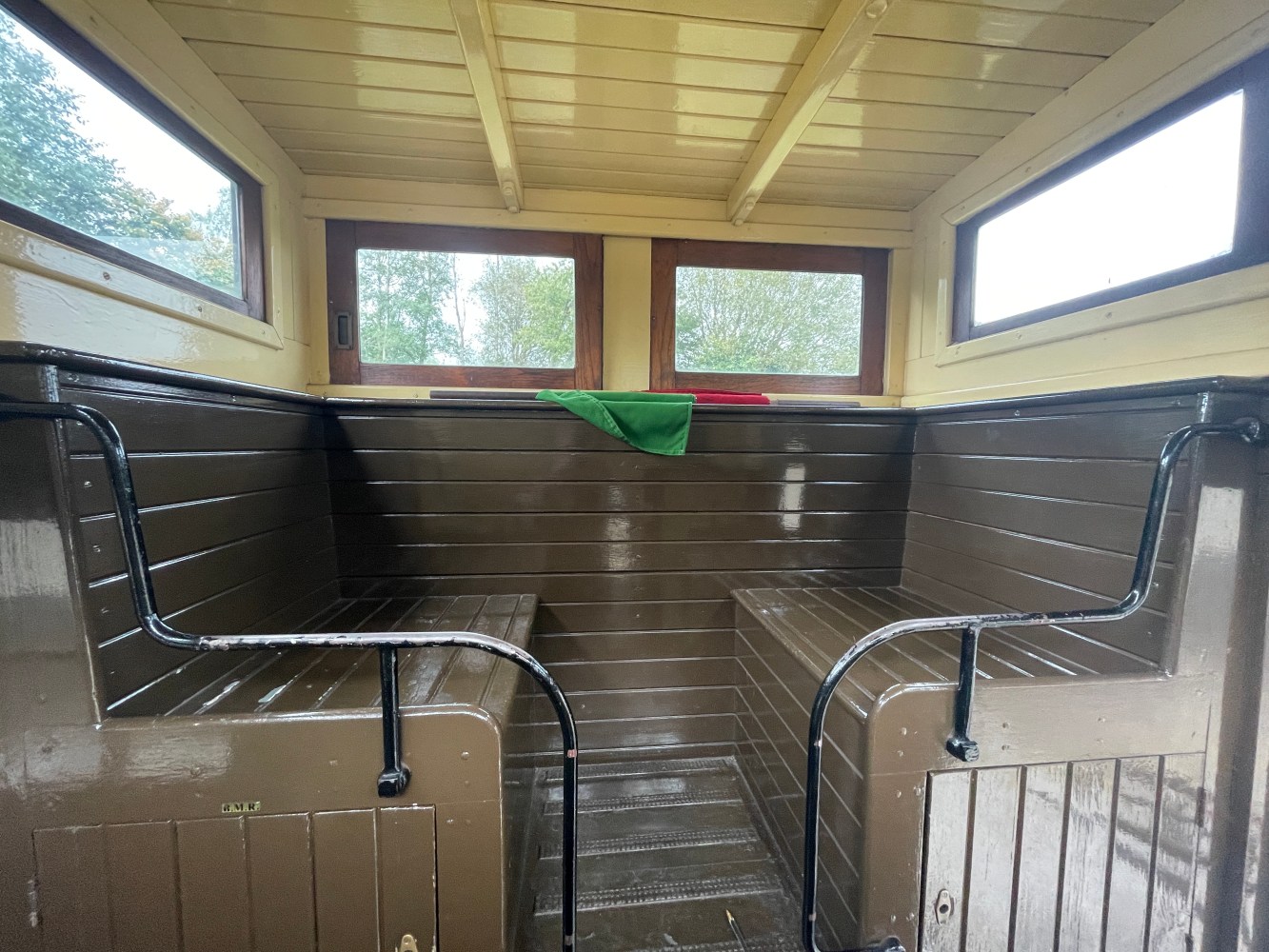 a wooden bench sitting next to a window