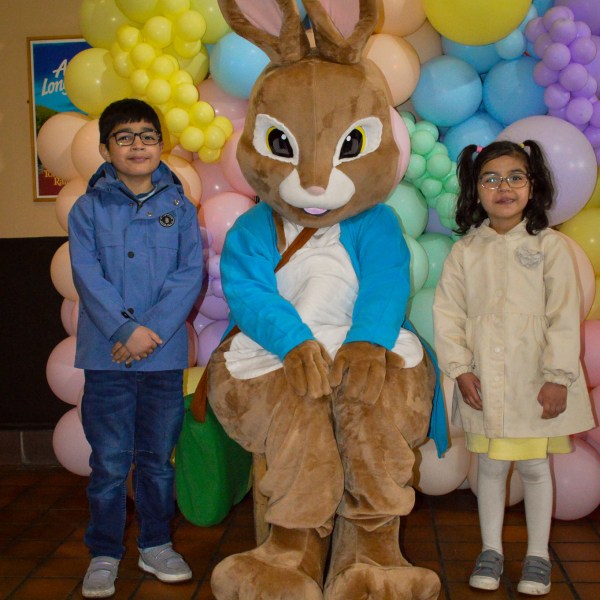 a group of teddy bears standing next to a pile of stuffed animals