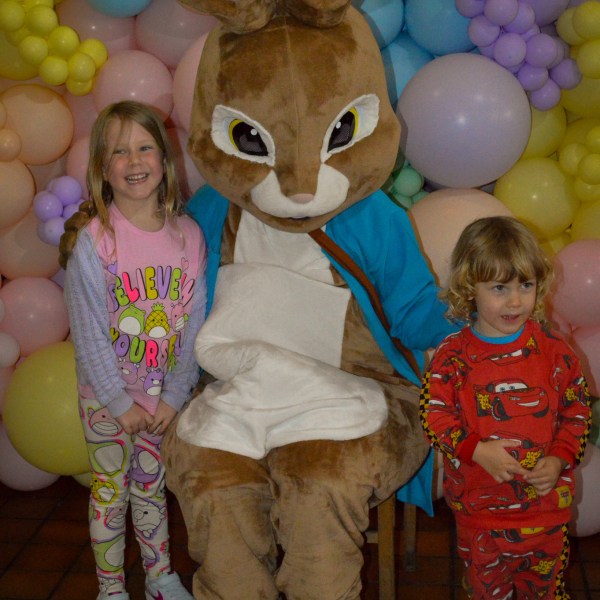 a group of teddy bears standing next to a child