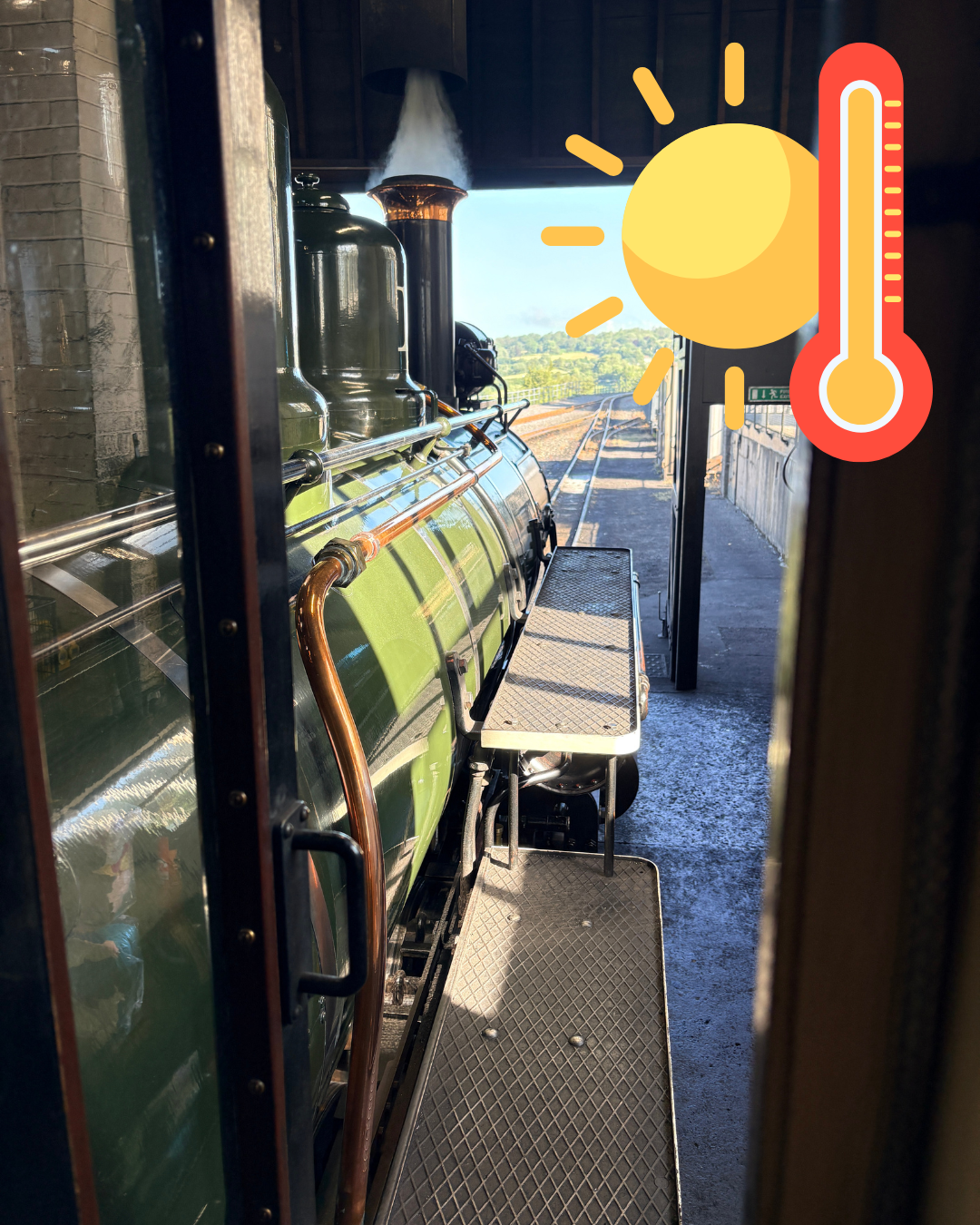 Steam train seen from a window with sun and temperature emoji.